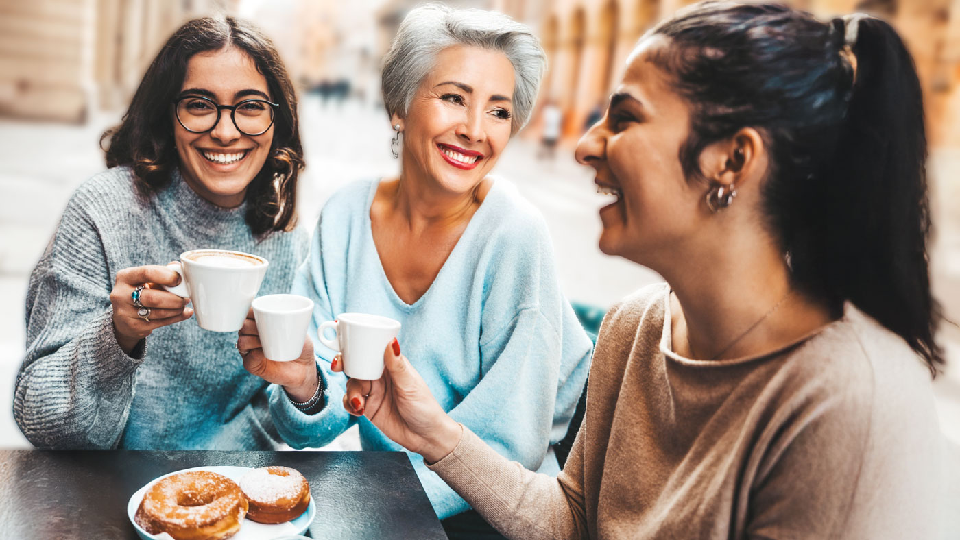 group of happy women friends enjoying coffee and their friendship